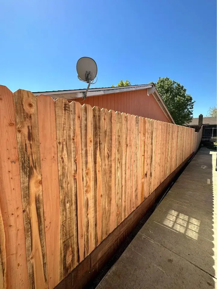 a long cedar wooden fence for a wood fence vs vinyl fence comparison