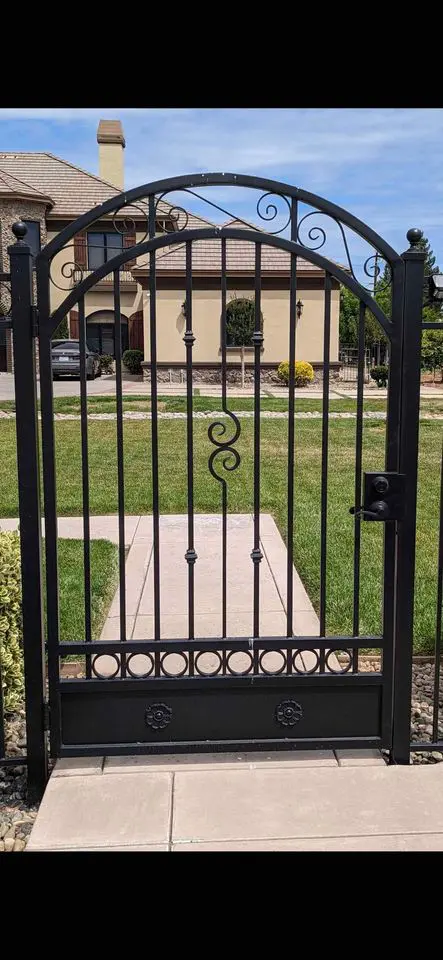 Custom iron walking gate designed, made and installed by Reno Fence and Gate